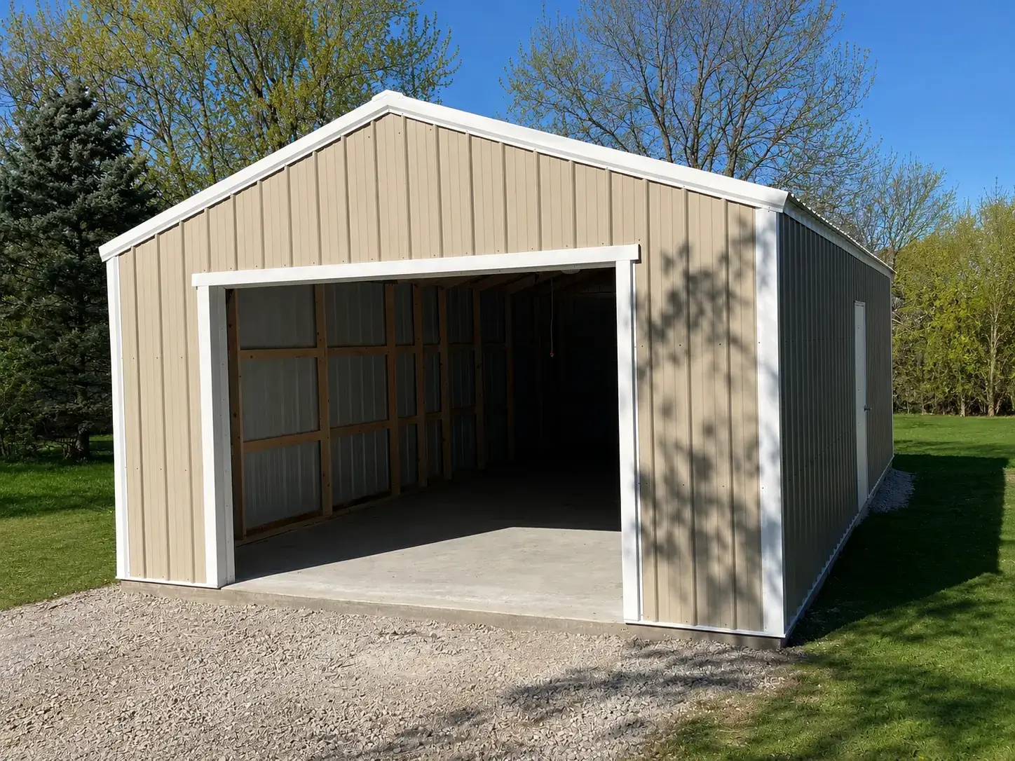 Tan portable garage with white trim and a wide open garage door opening