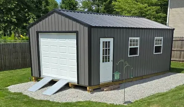 Dark gray portable garage with a white overhead door, walk-in door, and windows