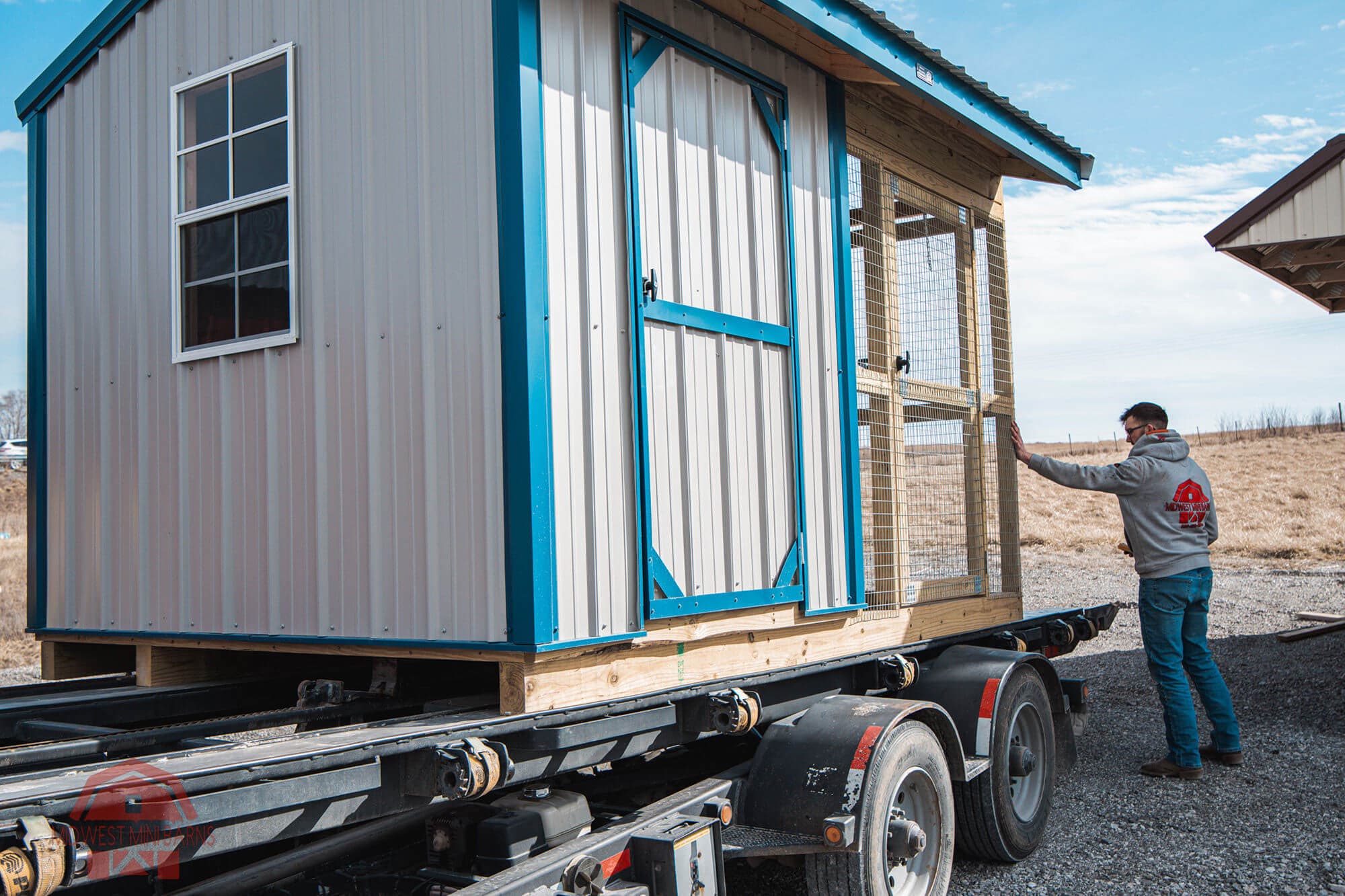 Portable chicken coop loaded on a trailer for delivery